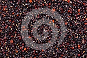 Black quinoa seeds background. Pile of raw kinwa. Top view.