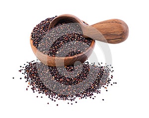 Black quinoa seeds in wooden bowl and spoon, isolated on white background. Pile of raw kinwa.