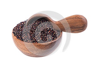 Black quinoa seeds in wooden bowl and spoon, isolated on white background. Pile of raw kinwa.