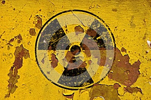 Black radioactive sign over yellow background photo