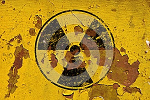 Black radioactive sign over yellow background