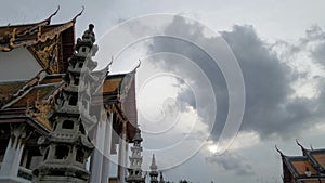 Black rain cloud over colourful temple roof