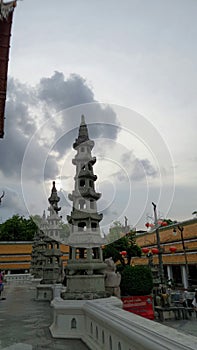 Black rain cloud over colourful temple roof