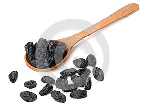 black raisins in wooden spoon isolated on white background photo