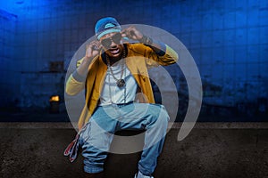 Black rapper in underpass, grunge subway photo