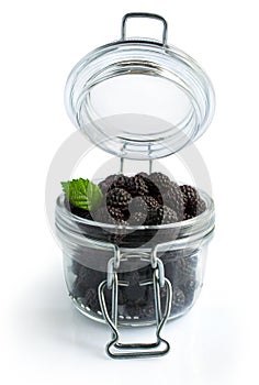 Black raspberries or blackberries in a glass jar