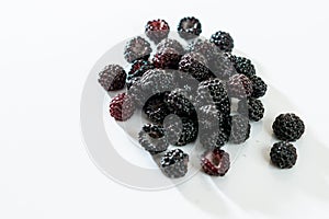 Black raspberry is fragrant and delicious on a white background