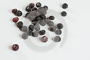 Black raspberry is fragrant and delicious on a white background