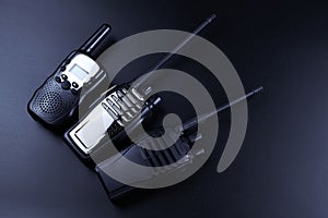 Black rectangle portable device with antenna isolated on black background. radio transceiver set for communication