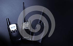 Black rectangle portable device with antenna isolated on black background. radio transceiver set for communication