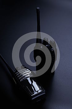 Black rectangle portable device with antenna isolated on black background. radio transceiver set for communication