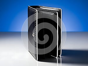 A black rectangular object with white lines on a reflective surface