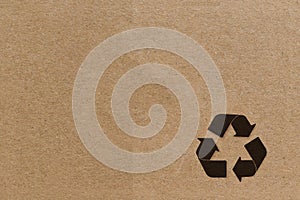 Black recycle symbol on cardboard background