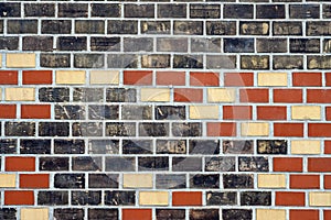 Black, red and beige brick wall