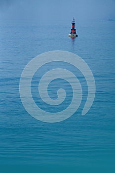 Black and red buoy on the sea