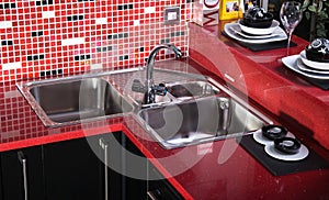 Black and red counter top in kitchen whit sink