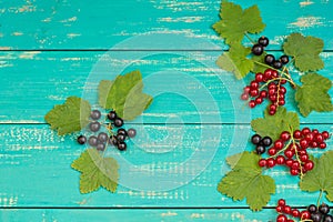 Black, red currant and strawberries on old background. Top view. Close-up