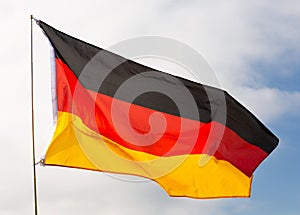 National flag of Germany waving on flagpole against sky photo