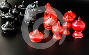 Black and Red group of Thai chess piece challenge on black background and selective focus