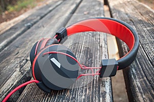 black and red headphones on wooden table in outdoor