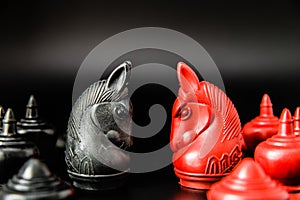Black and Red Knight Thai chess piece challenge on black background and selective focus