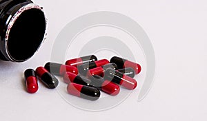 Black-red, medicament, pill throw from box on white background