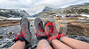 Black and red mountain hiking boots towards mountain scenery