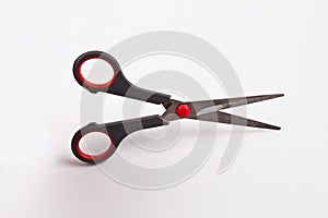 Black and red scissors isolated on white background, clipping path included.