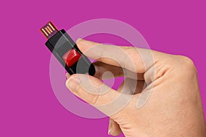 Black and red USB flash memory in hand