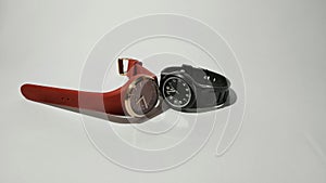 Black and red watch on white background surface