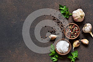 Black, red and white peppersalt, salt, garlic in a wooden bowl . Classic spices for cooking. View from above