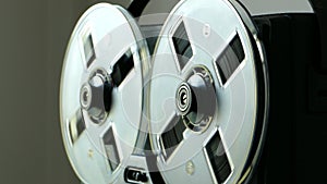 Black reel to reel tape recorder. Rewinds retro tape. Vintage music player close up. Spinning reels transparent. 4K 2160p 25fps Ap