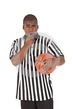 Black referee blowing whistle holding basketball
