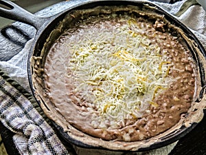 Black Refried Beans in Iron Skillet with Cheese photo