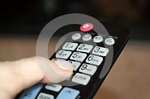 Black remote control with numbers and other commands