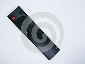 A black remote control with various buttons on a white background