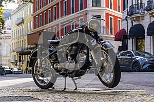 Black retro motorcycle parked in downtown