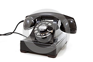 A black retro rotary phone on a white background