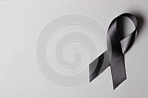 Black ribbon on a gray background.