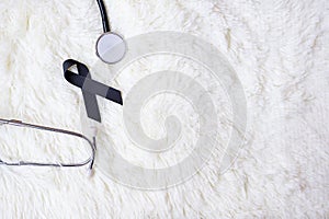 Black Ribbon and stethoscope on white background. Melanoma and skin cancer, Vaccine injury awareness month and rest in peace