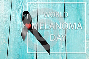 Black ribbon-symbol of fight against melanoma and skin cancer.