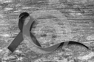 Black Ribbon symbolic color raising awareness on Melanoma and skin cancer prevention and world peace mourning remembrance concept
