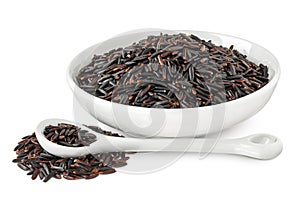 Black rice in ceramic bowl and spoon isolated on white background with full depth of field