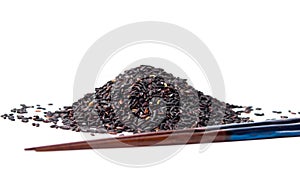 Black rice grains pile with chopsticks isolated