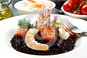 Black rice with sliced squids ,prawns and tomato