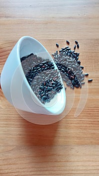 Black rice is a type of rice that contains higher amounts of anthocyanins in aleron than white rice. photo