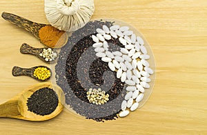 Black rice and white pill forming a yin yang symbol and Spa herbal