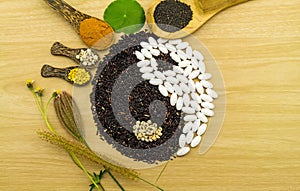 Black rice and white pill forming a yin yang symbol and Spa herbal compressing ball , turmeric powder , millet , soybean , basil s