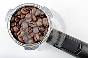 Black roasted coffee beans and a coffee machine flask. Coffee making accessories