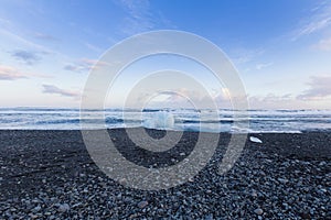 Black rock and sand beach coastline winter season landscape